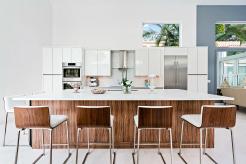 Contempo Kitchen, where high-gloss white cabinets meet the warmth of a wood-textured island. This bold blend of materials adds a perfect balance of sleek sophistication and natural charm—just the kind of contrast that takes your space from ordinary to unforgettable.