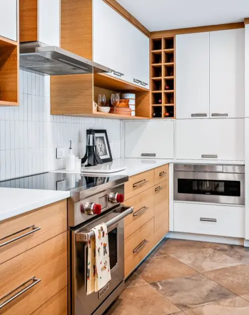 Contemporary kitchen with a blend of white and natural wood finished cabinets paired with a white quartz countertop