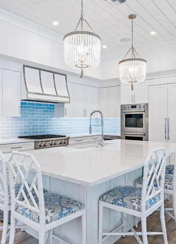 Elegant and modern coastal style kitchen with white cabinetry and coastal accents 