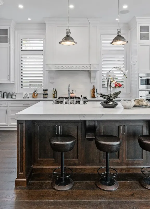 Traditional style kitchen with large kitchen island with seating, and white cabinetry 