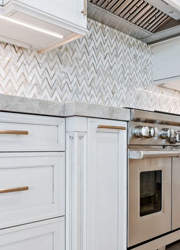 Mondern kitchen design with  hand tiled backsplash and marble countertops